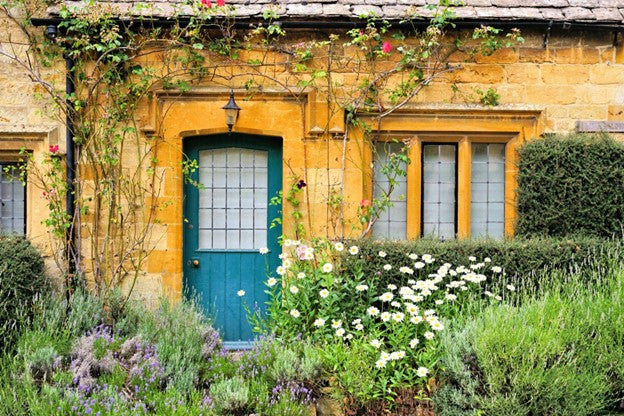 Cottage-style garden with layered planting and hedgerows creating natural privacy